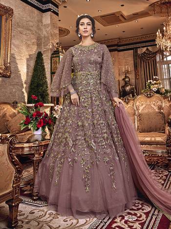 New Shade In Purple Is Here With This Heavy Designer Floor Length Suit In Mauve Color. This Beautiful Patterned And Heavy Embroidered Floor Length Top Is Fabricated On Net Paired With Santoon Bottom And Net Fabricated Dupatta. Buy Now.