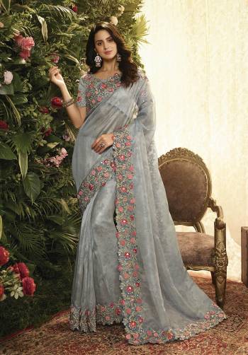 This Wedding Season, Look The Most Elegant Of All Wearing This Heavy Designer Saree In Grey Color. This Heavy Contrasting Embroidered Saree Is Fabricated On Orgenza Paired With Art Silk Fabricated Blouse. 