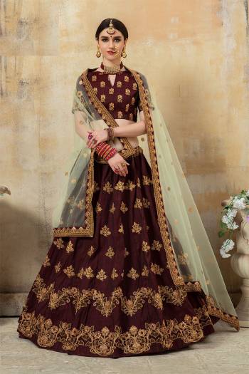 For A Bold And Beautiful Look, Grab This Very Beautiful And Attractive Lehenga Choli In Maroon Color Paired With Cream Colored Dupatta. Its Blouse And Lehenga Are Silk Based Paired With Net Fabricated Dupatta. Buy Now.