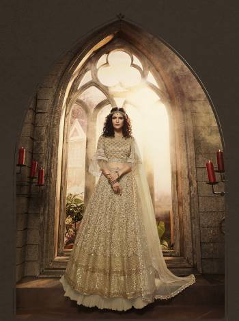 Here Is A Beautiful Lehenga Choli In All Over Beige Color. Thisw Pretty Heavy Embroidered Lehenga Choli Is Net Based Beautified With Heavy Detailed Embroidery. Its Attractive Embroidery And Rich Color Will Definitely Earn You Lots Of Compliments From Onlookers.