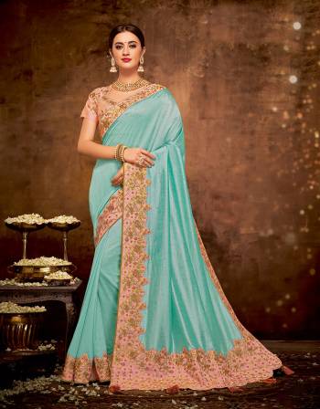 Radiate vivacious vibes and regal aura in this bright Turquoise blue saree paired with peach hues . Adorn it with maharani necklace to look glorious. 