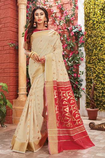 Flaunt Your Rich And Elegant Taste Wearing This Rich Silk Based Saree In Cream Color Paired With Contrasting Red Colored Blouse. This Saree Is Fabricated On Cotton Silk Paired With Art Silk Fabricated Blouse. Its Rich Color Pallete And Fabric Will Definitely Earn You Lots Of Compliments From Onlookers.