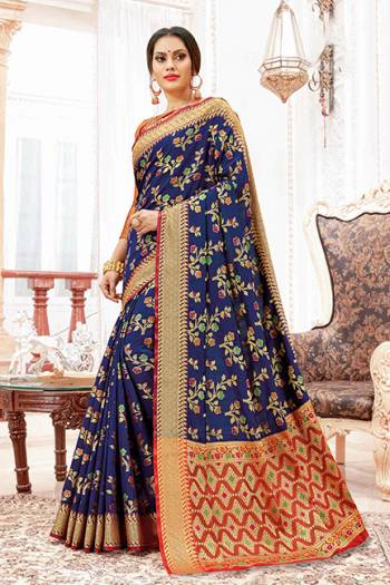 For A Proper Traditional Look, Grab This Designer Saree In Navy Blue Color Paired With Contrasting Red Colored Blouse. This Saree And Blouse Are Silk Based Which Gives A Rich Look To Your Personality. 