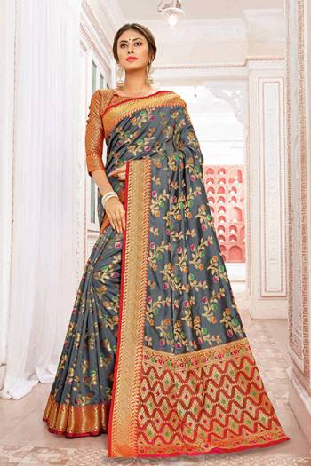 For A Proper Traditional Look, Grab This Designer Saree In Dark Grey Color Paired With Contrasting Red Colored Blouse. This Saree And Blouse Are Silk Based Which Gives A Rich Look To Your Personality. 