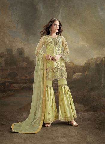 Look Pretty In This Designer Suit In Pretty Light Yellow Color. Its Top, Bottom And Dupatta Are Fabricated On Net. It Is Beautified With Subtle Tone To Tone Resham Embroidery Highlighted With Jari & Stone Work. 