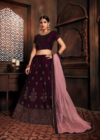 You Will Definitely Earn Lots Of Compliments In This Elegant Looking Designer Lehenga Choli In Wine Color Paired With Pink Colored Dupatta. This Beautiful Lehenga Choli Is Fabricated On Velvet Paired With Net Fabricated Dupatta. It Is Beautified With Attractive Stone Work All Over. 