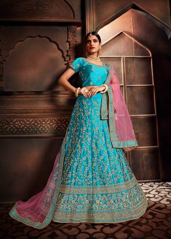 Add This Beautiful Lehenga Choli To Your Wardrobe For This Festive Season With This Lovely Blue Colored Lehenga Choli Paired With Contrasting Pink Colored Dupatta. This Lehenga Choli Is Silk Based Paired With Net Fabricated Dupatta. Buy Now.