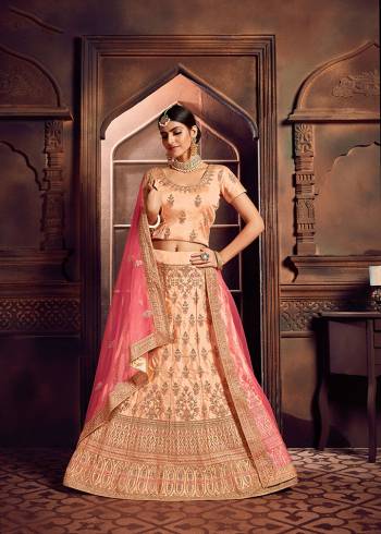 Add This Beautiful Lehenga Choli To Your Wardrobe For This Festive Season With This Lovely Light Peach Colored Lehenga Choli Paired With Contrasting Pink Colored Dupatta. This Lehenga Choli Is Silk Based Paired With Net Fabricated Dupatta. Buy Now.