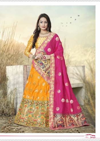 This Festive Season Have A Proper Traditional Look Wearing This Silk Based Lehenga Choli In Musturd Yellow Color Paired With Contrasting Rani Pink Colored Dupatta. This Lehenga Choli Is Fabricated On Banarasi Jacquard Silk Beautified With Weave All Over.