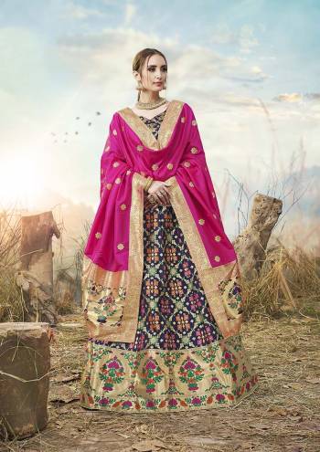 Go With Pretty Shades Wearing This Heavy Weaved Designer?Lehenga Choli In Navy Blue Color Paired With Contrasting Rani Pink Colored Dupatta. Its Blouse Is Fabricated On Banarasi Art Silk Paired With Banarasi Jacquard Silk Lehenga And Dupatta