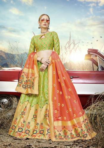 Look Pretty In This Designer Silk Based Lehenga Choli In Light Green Color Paired With Contrasting Orange Colored Dupatta. It Is Fabricated On Banarasi Jacquard Silk Beautified With Weave All Over. Buy This Pretty Piece Now.?