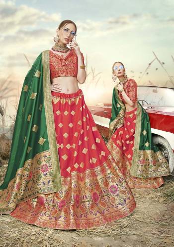 Shine Bright In This Very Beautiful Designer Lehenga Choli In Red And Orange Color Paired With Contrasting Green Colored Dupatta. This Lehenga Choli Is Fabricated On Banarasi Jacquard Silk Beautified With Weave All Over.