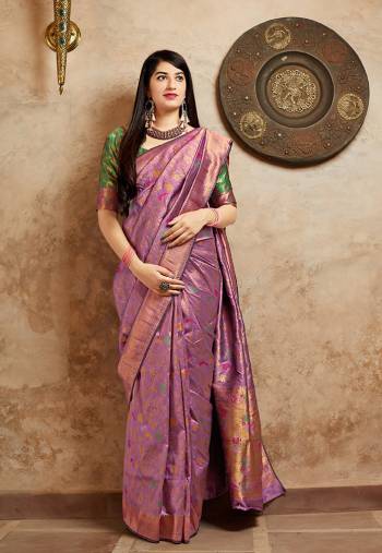 For An Elegant Pretty Look, Grab This Designer Saree In Light Purple Color Paired With Green Colored Blouse. This Saree And Blouse Are Banarasi Art Silk Based Beautified With Attractive Weave All Over. Buy Now.