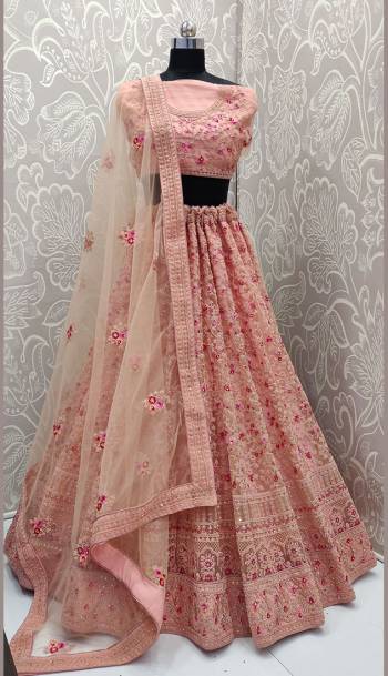 This Wedding Season, Look The Most Graceful Of All Wearing This Heavy Designer Lehenga Choli In Peach Color. Its Blouse, Lehenga And Dupatta are Fabricated on Net Beautified With Tone To Tone Coding Work And Contrasting Resham Embroidery With Stone Work. Buy Now.