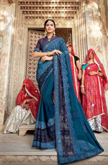 Enhance Your Personality In This Beautiful and Heavy Embroidered Designer Saree In Blue color Paired With Navy Blue Colored Blouse. This Saree Is Fabricated On Georgette Paired With art silk Fabricated Blouse. 