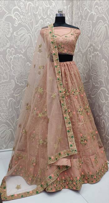 You Will Definitely Earn Lots Of Compliments Wearing This Heavy Designer Lehenga Choli In All Over Dusty Peach Color. Its Heavy Embroidered Blouse, Lehenga And Dupatta Are Fabricated On Net. Its Detailed Embroidery And Lovely Color will Give You A Look Like Never Before. 