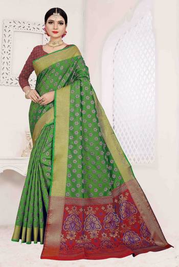 Here Is A Designer Silk Based Saree In Green Color Paired With Red Colored Blouse. This Saree And Blouse Are Fabricated On Patola Art Silk Beautified With Weave All Over. It Is Light Weight And Easy To Carry All Day Long. 