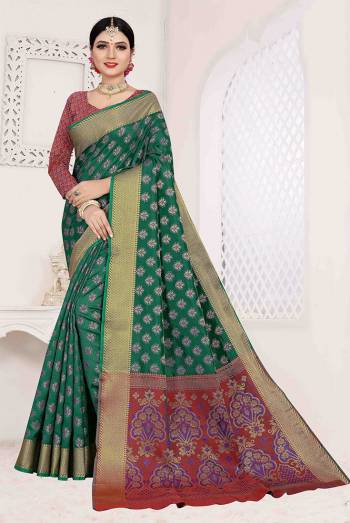 Here Is A Designer Silk Based Saree In Green Color Paired With Red Colored Blouse. This Saree And Blouse Are Fabricated On Patola Art Silk Beautified With Weave All Over. It Is Light Weight And Easy To Carry All Day Long. 