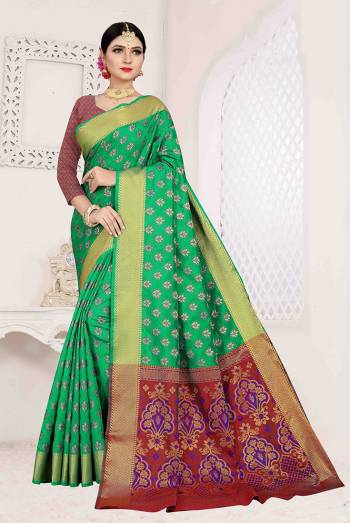 Here Is A Designer Silk Based Saree In Green Color Paired With Red Colored Blouse. This Saree And Blouse Are Fabricated On Patola Art Silk Beautified With Weave All Over. It Is Light Weight And Easy To Carry All Day Long. 