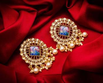 Grab This Beautiful And Attractive Pair Of Elegant Earrings Set In?Golden Color. This Pretty Pair Is Beautified With Stone Work And Can Be Paired With Any Colored Traditional Attire. Buy Now.