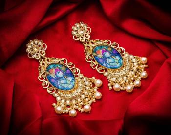 Grab This Beautiful And Attractive Pair Of Elegant Earrings Set In?Golden Color. This Pretty Pair Is Beautified With Stone Work And Can Be Paired With Any Colored Traditional Attire. Buy Now.