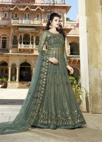 Here Is An Elegant Girly Shade With This Heavy Designer Floor Length Suit In Teal Green Color. Its Top And dupatta are Net Based Beautified With Heavy Embroidery Paired With Satin Fabricated Bottom. 