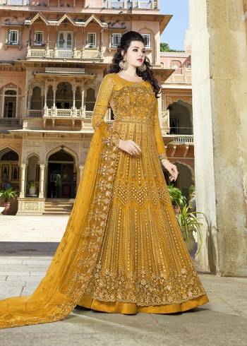 Here Is An Elegant Girly Shade With This Heavy Designer Floor Length Suit In Musturd Yellow Color. Its Top And dupatta are Net Based Beautified With Heavy Embroidery Paired With Satin Fabricated Bottom. 