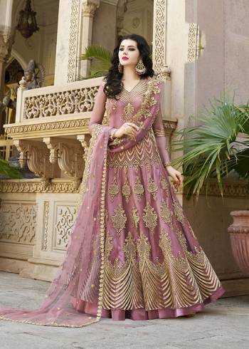 Look Pretty Wearing This Heavy Designer Floor Length Suit In Net Based Which Is In All Over Pink Color. Its Top And Dupatta Are Beautified With Heavy Embroidery Which Gives An Attractive Look To Your Personality. 