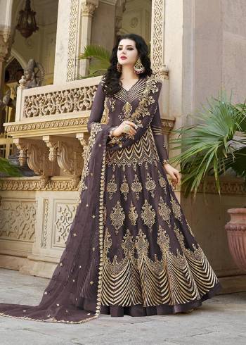 Look Pretty Wearing This Heavy Designer Floor Length Suit In Net Based Which Is In All Over Dark Wine Color. Its Top And Dupatta Are Beautified With Heavy Embroidery Which Gives An Attractive Look To Your Personality. 