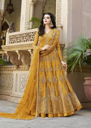 Look Pretty Wearing This Heavy Designer Floor Length Suit In Net Based Which Is In All Over Musturd Yellow Color. Its Top And Dupatta Are Beautified With Heavy Embroidery Which Gives An Attractive Look To Your Personality. 