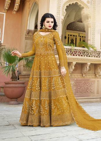 You Will Definitely Earn Lots of Compliments Wearing This Heavy Designer Floor Length Suit In Musturd Yellow Color. Its Heavy Embroidered Top and Dupatta Are Net Based Paired With Satin Fabricated Bottom. Buy Now.