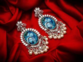 Grab This Beautiful And Attractive Pair Of Elegant Earrings Set In Silver Color. This Pretty Pair Is Beautified With Stone Work And Can Be Paired With Any Colored Traditional Attire. Buy Now.