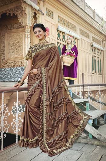 For A Royal Look, Grab This Designer Fancy Saree With Cape In All Over Brown Color. This Pretty Saree Is Fabricated On Lycra Paired With Art Silk Fabricated Blouse And Embroidered Net Fabricated Cape. Its Trendy Pattern And Design Will Earn You Lots Of Compliments From Onlookers.