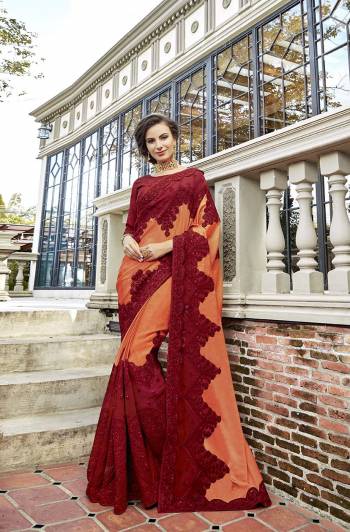 You Will Definitely Earn Lots Of Compliments Wearing This Attractive Looking Heavy Designer Saree In Orange And Maroon Color Paired With Maroon Colored Blouse. This Pretty Detailed Embroidered Saree Is Satin Georgette Based Paired With art Silk Fabricated Embroidered Blouse. 