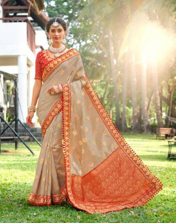 Flaunt Your Rich And Elegant Taste In Subtle And Elegant Shades With This Designer Saree In Pale Grey Color Paired With Contrasting Red colored Blouse. This Silk Based Saree And Its Elegant Color Pallete Will Give A Great Look To Your Personality.  