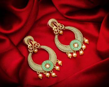 Here Is A Lovely Pair Of Earrings In Golden Color With Pastel Green Highlight And Stone Work. This Can Be Paired With Any Heavy Attire Or A Simple Kurti .