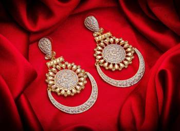 Here Is A Lovely Pair Of Earrings In Golden Color With Grey Highlight And Stone Work. This Can Be Paired With Any Heavy Attire Or A Simple Kurti .