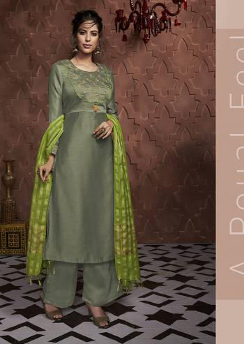 Go With The Shades Of Green With This Readymade Suit In Olive Green Color Paired With Parrot Green Colored Dupatta. This Suit Is Fabricated On Soft Silk Paired With Banarasi Silk Fabricated Dupatta. 