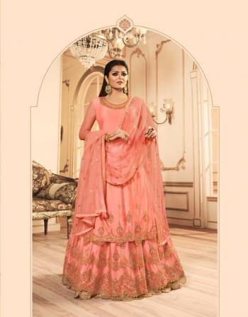 A Must Have Shade In Every Womens Wardrobe Is Here With This Designer Indo-Western Suit In Peach Color Which Comes With Two Bottom. Its pretty Embroidered Top, Lehenga And Dupatta are Net Based Paired With A Santoon Fabricated Bottom. 