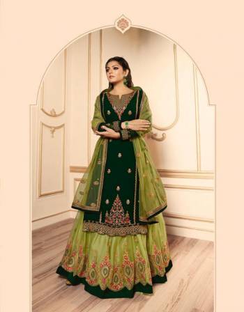 Pretty Shades Of Green Are Here With This Designer Heavy Indo-Western Suit In Dark Green And Light Green Color. Its Top IS Fabricated On Satin Georgette Paired With Two Bottoms, One In Santoon And Another In Net Fabricated Lehenga And Net Dupatta. All Its Fabric Are Durable, Light Weight And Easy To Carry All Day Long. 