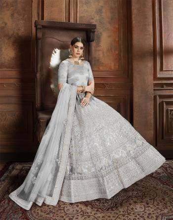 Flaunt Your Rich And Elegant Taste Wearing This Heavy Designer Lehenga Choli In Light Grey Color. This Beautifully Embroidered Heavy Lehenga Choli And Its Dupatta Are Fabricated On Net. Its Elegant Color And Detailed Embroidery Will Earn You Lots Of Compliments From Onlookers. 