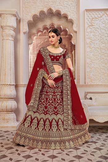 Get Ready For Your D-Day With This Heavy Designer Lehenga Choli In?All Over Maroon Color. This Heavy Embroidered Lehenga Choli Is Fabricated On Velvet Paired With Net Fabricated Dupatta. It Is Beautified With Heavy Coding Jari Embroidery. Buy This Bridal Lehenga Now.