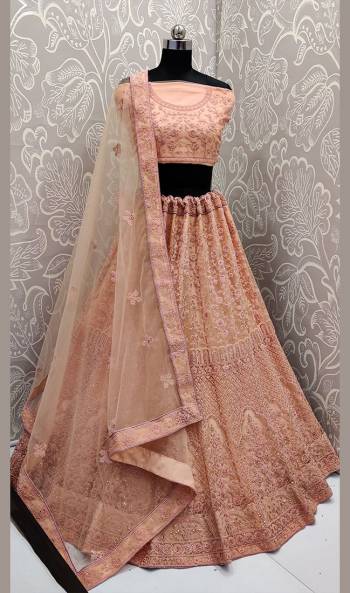 Very Beautiful And Heavy Embroidered Lehenga Choli Is Here In Peach Color With Detailed Tone-To-Tone Embroidery All Over. This Heavy Embroidered Lehenga Choli Is Fabricated On Net. Its Fabric Ensures Superb Comfort Throughout The Gala. Buy Now.