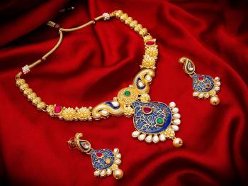 Give An Enhanced Look To Your Personality By Pairing Up This Beautiful Necklace Set With Your Ethnic Attire. This Pretty Set Is In Golden Color Beautified With Stone And Pearl Work. Buy Now.