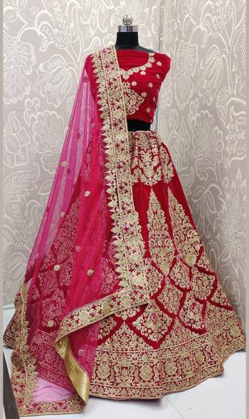 Here Is A Beautiful Designer Bridal Lehenga Choli In Rani Pink Color. This Beautiful Heavy Lehenga Choli Is Fabricated On Velvet Paired With Net Fabricated Dupatta. It Is Beautified With Heavy Detailed Embroidery. Get Ready For Your D-Day With This Designer Piece And Look The Most Graceful Of All. 