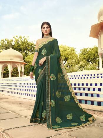 Celebrate This Festive Season With Beauty And Comfort Wearing This Heavy Designer Saree In Pine Green Color Paired With Cream Colored Blouse. This Saree Is Chiffon Based Paired With art Silk Fabricated Blouse. It Is Light In Weight And Easy To Carry All Day Long. 