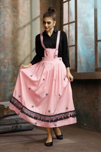 Grab This Pretty Two-Piece Readymade Dress Which Has A Black Colored Shirt Paired With A Dungaree Dress In Pink Color. The Shirt Is Fabricated on Rayon Paired With Cotton Based Over Dress. It Is Light In Weight And Easy To Carry All Day Long. 