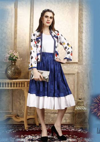 Here Is A Pretty Three Piece Western Set In White Colored Top Paired With Blue Colored Skirt And White Colored Printed Jacket. Its Top Is Fabricated on Cotton Lycra Paired With Rayon Fabricated Skirt and Jacket. 