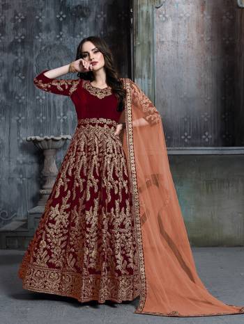 Get Ready For The Upcoming Wedding And Festive Season Wearing This Heavy Designer Floor Length Suit  In Red Color Paired With Light Orange Colored Dupatta. Its Heavy Embroidered Top Is Fabricated on Velvet Paired With Santoon Bottom And Net Fabricated Dupatta. 