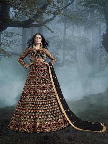 Grab This Heavy Designer Floor Length Suit In Black Color For The Upcoming Wedding Season. This Very Beautiful And Heavy Embroidered Floor Length Top Is Fabricated On Net Paired With Silk based Bottom And Net Fabricated Dupatta. Its Detailed Embroidery With Perfect Color Combination Will Earn You Lots Of Compliments From Onlookers.